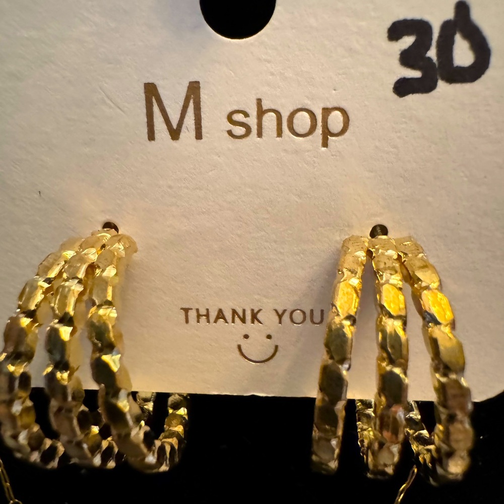 New pair of hoop style earrings. Gold tone.